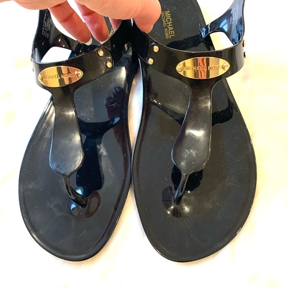 Black and gold Michael Kors thong sandals. - Picture 1 of 5